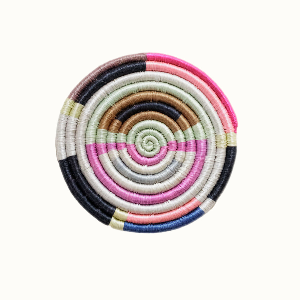 Colorful spiral-patterned coaster on a white background