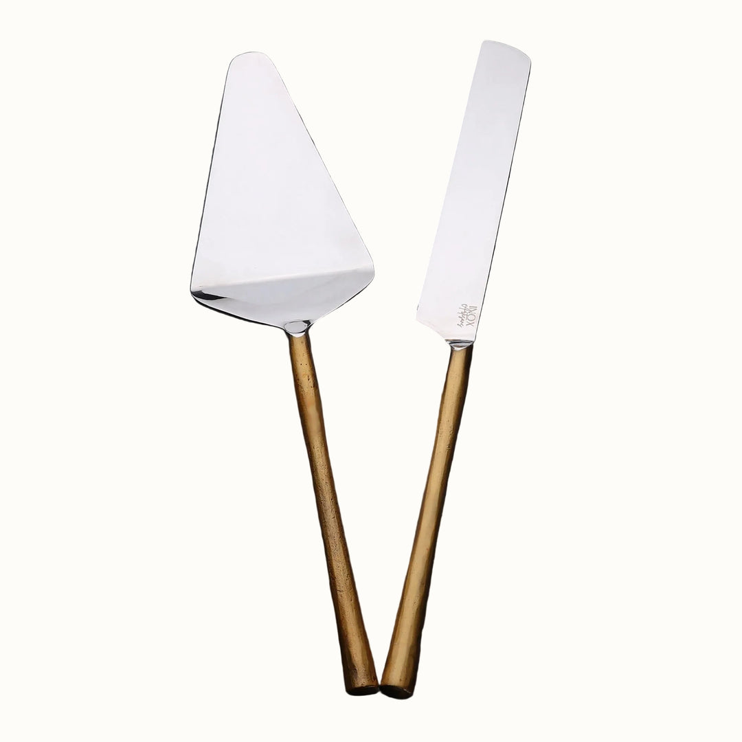 Two cake knives with wooden handles on a dark surface