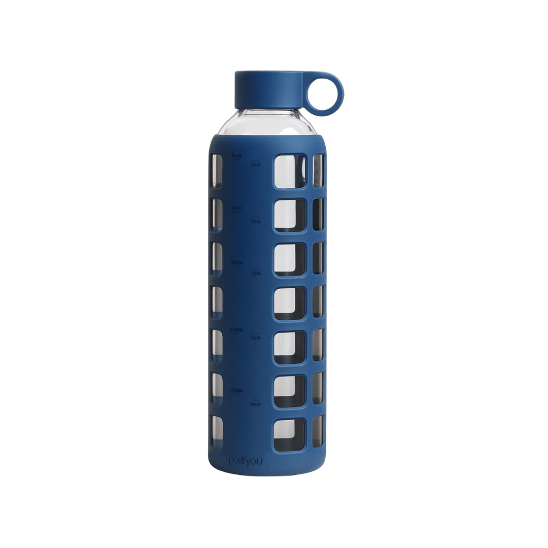 A blue reusable water bottle with a clear glass body, a blue silicone protective sleeve featuring square cutouts, a matching blue screw-on cap, and a small loop handle on the cap, shown on a plain white background.