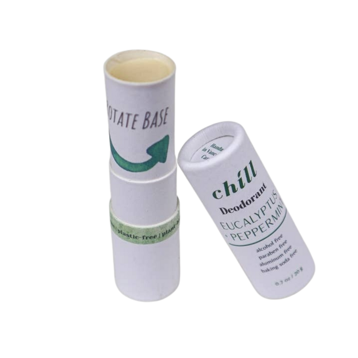 A white cylindrical deodorant stick and its matching cap on a plain white background. The cap reads &