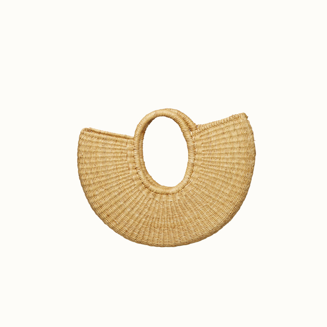 Woven handbag on a beige background