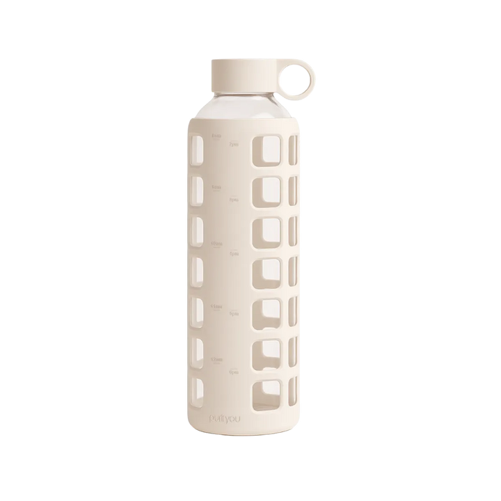 A tall, cylindrical water bottle with a light beige silicone sleeve featuring square cutouts, a matching beige cap, and a small loop handle, shown on a plain white background.