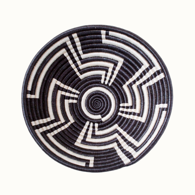 Black and white woven bowl on a white background