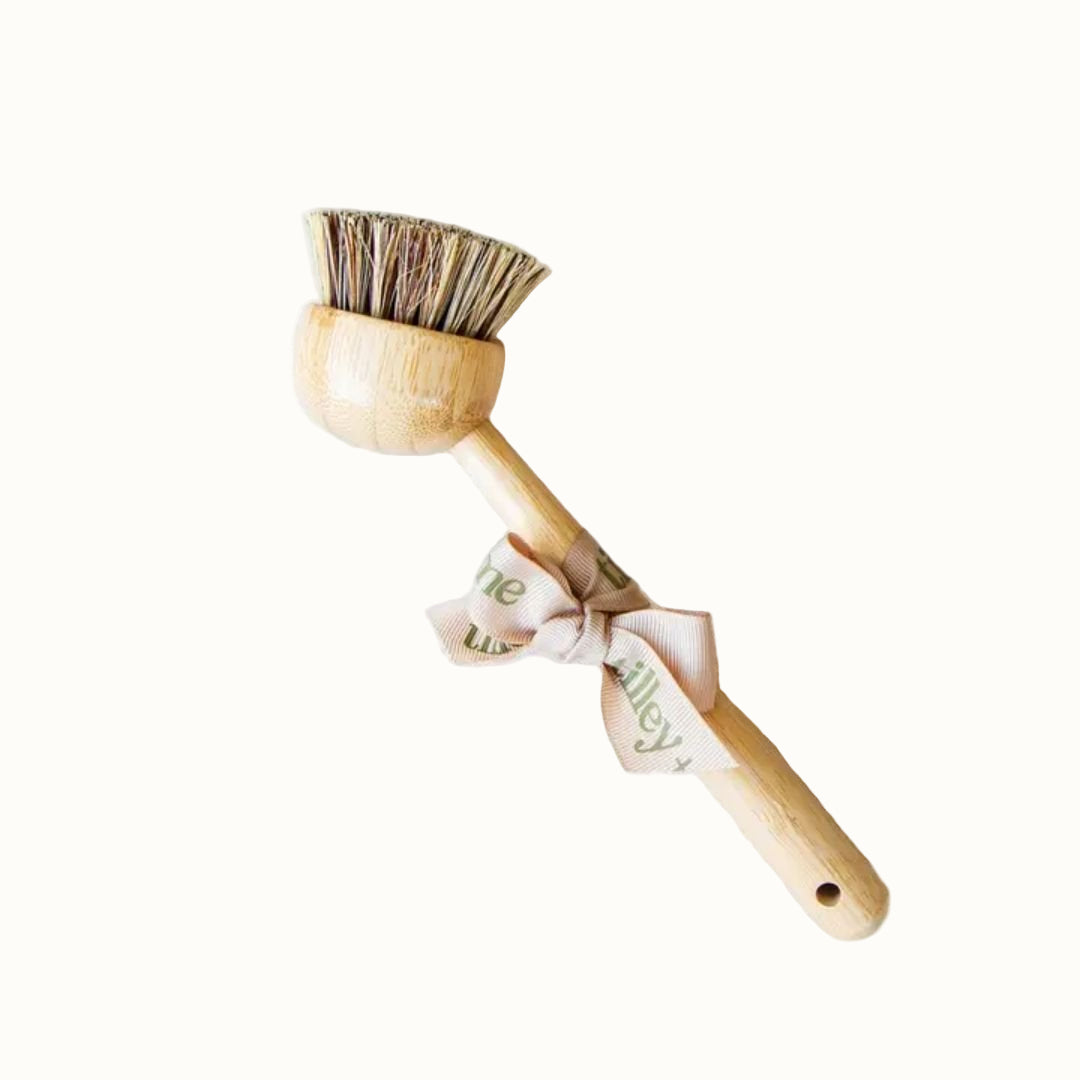 Wooden brush with bristle head and decorative handle on a light background