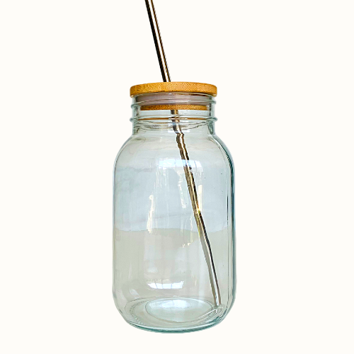 Clear glass jar with a wooden lid on a white background