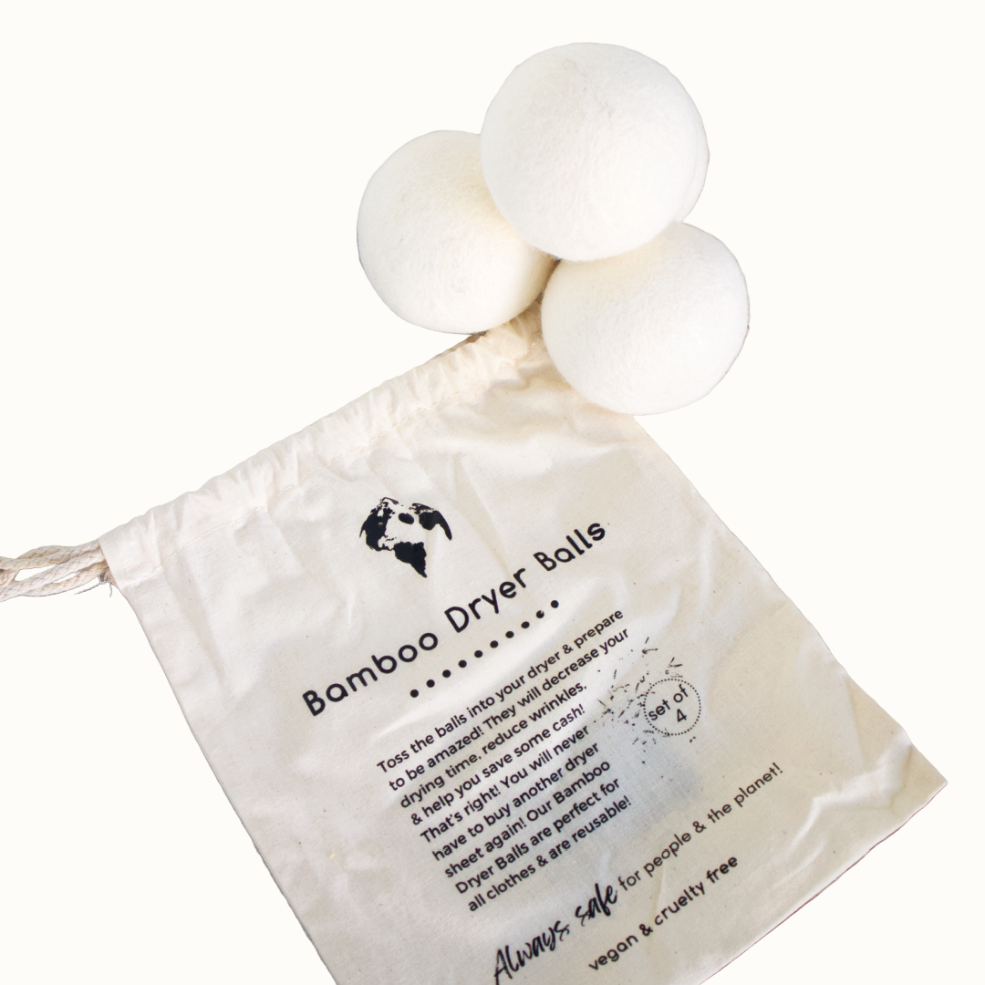 Bamboo dryer balls with a cloth bag on a wooden surface